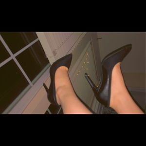 Pointed black heels.